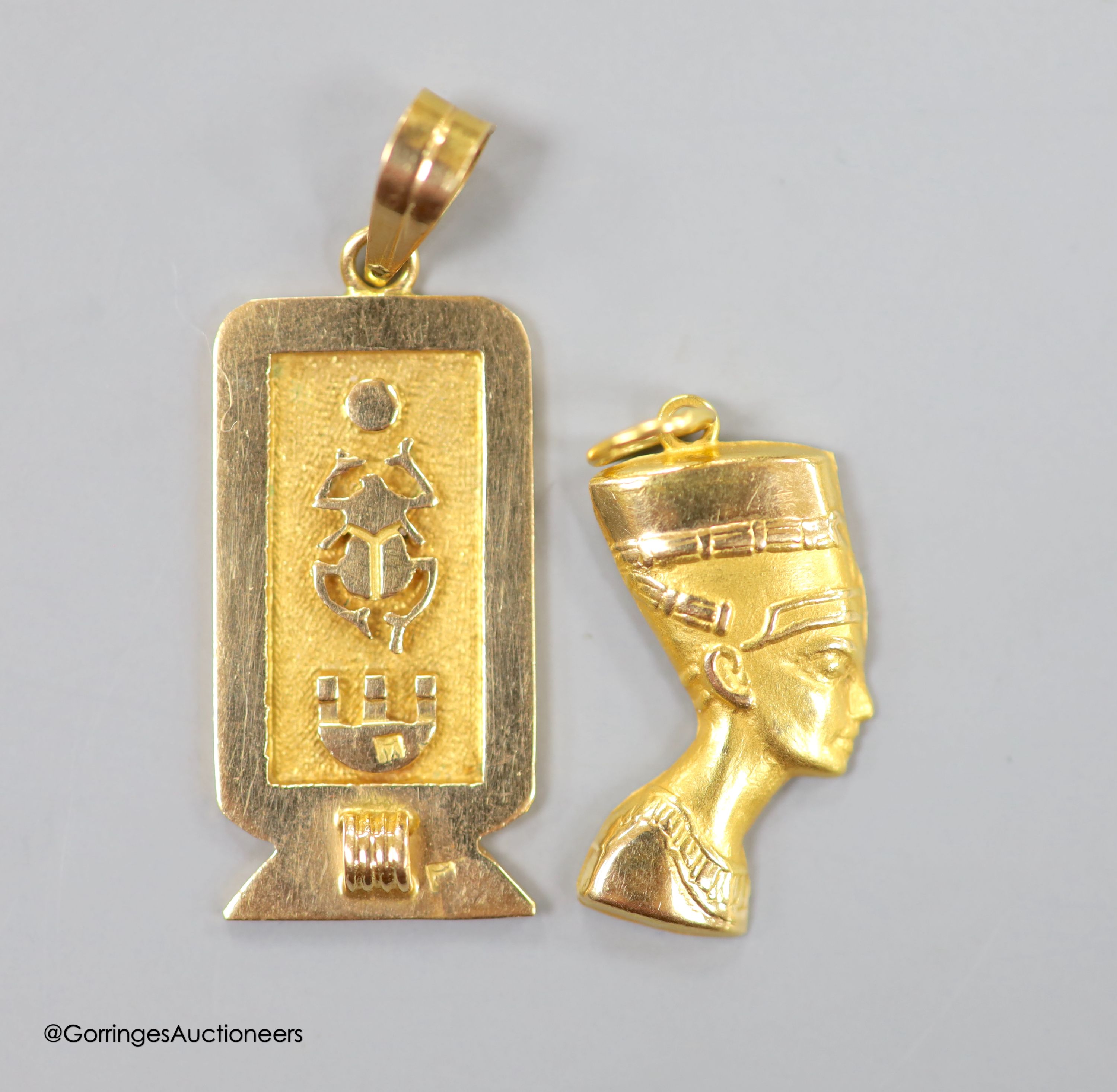 Two Egyptian gold charms (tested as 18ct), gross 6.3 grams.